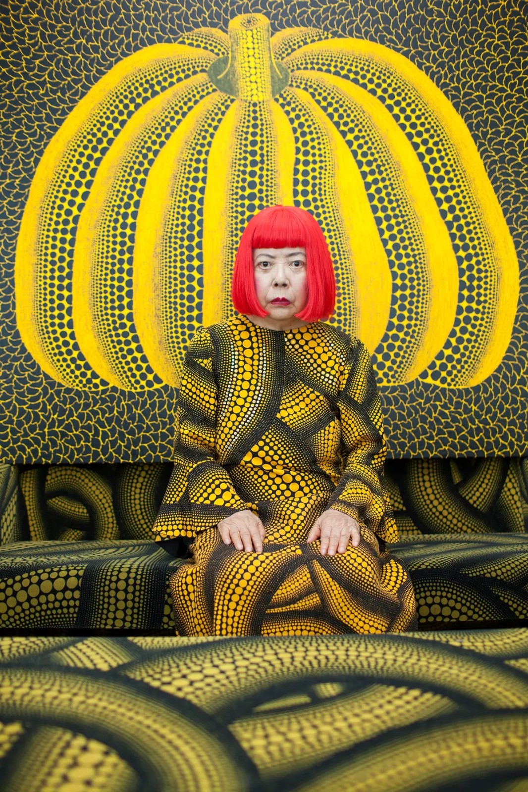 Portrait of Yayoi Kusama in costume in front of pumpkin painting, photo by Noriko Takasugi.webp.jpg